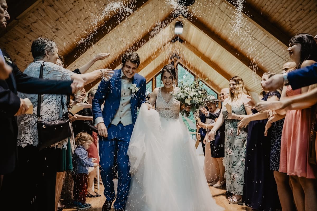 Guests showering confetti as the couple walks through