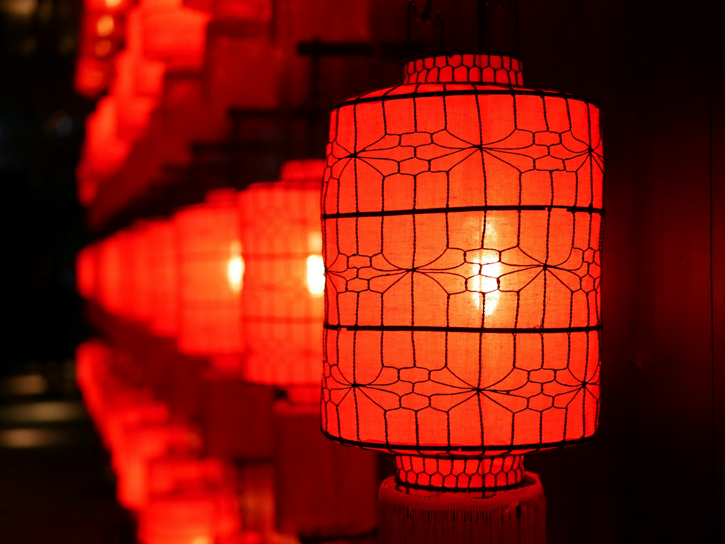 Red paper lanterns glowing softly in the dark